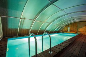 a swimming pool in a building with a tunnel at Vila Ambasada in Šventoji