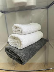 a group of towels are stacked in a glass rack at Terrigal Beach House in Terrigal