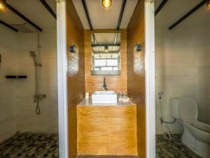 a bathroom with a sink and a toilet at Alam Kita Glamping & Plantation in Munduk