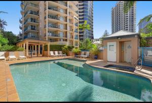a swimming pool in a apartment with a building at San Mateo On Broadbeach in Gold Coast