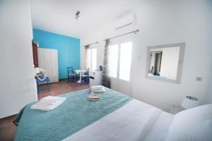 a bedroom with a bed with a blue and white at Agialos Rooms in Kalymnos