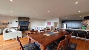 a living room with a wooden table and a kitchen at K2 - Thirteen in Mount Buller