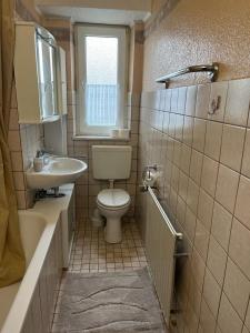 a bathroom with a toilet and a sink at Gästewohnung 1 OGL in der Nähe zur Veltinsarena - Gästewilli 3 in Gelsenkirchen