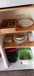 a wooden shelf with plates and dishes on it at Las Cafourques Chambre d'Hotes in Ségalas