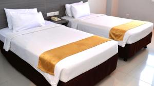 Voodi või voodid majutusasutuse Urban Style Hotel Lampung, Azana Hotels Collection toas