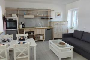 a living room with a couch and a table at Marvens Apartment in Zefiría
