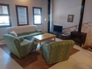 a living room with a couch and chairs and a table at Casas de La Ermita VTAR TANA in Puerto-Gil