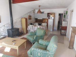a living room with a table and chairs and a stove at Casas de La Ermita VTAR TANA in Puerto-Gil