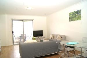 a living room with a couch and a table at Mill View Link in Albany