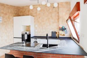 a kitchen with a sink and a counter top at Casa in zona residenziale in Nettuno