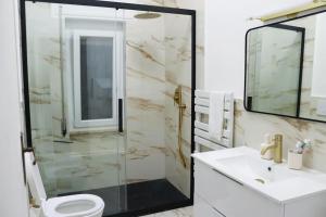 a bathroom with a shower and a toilet and a sink at Casa in zona residenziale in Nettuno +14 photos