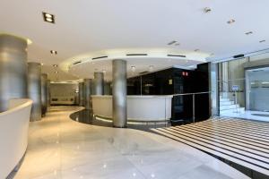 a lobby with a staircase in a building at Hotel Ciutadella Barcelona in Barcelona