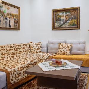 a living room with a couch and a table at Myrtilli Cottages Pelion in Áno Lekhónia