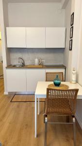 a kitchen with a white table and a sink at Politecnico Bovisa university apartment in Milan