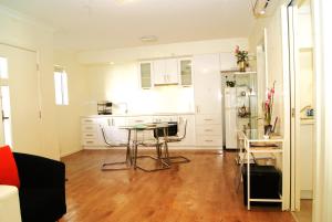 a kitchen with a table and chairs in a room at Mill View Link in Albany