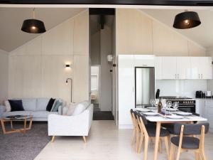 a kitchen and living room with a table and chairs at Jacks Lodge Townhouse in Hanmer Springs +19 photos