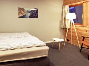 a bedroom with a bed and a desk and a lamp at 19 person holiday home in Jøsenfjorden-By Traum in Gullingen