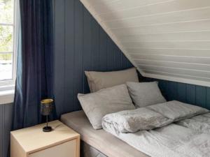 a bed in a room with blue walls at 6 person holiday home in Gursken-By Traum in Larsnes