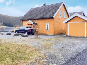 a truck parked in front of a house at 6 person holiday home in Gursken-By Traum in Larsnes