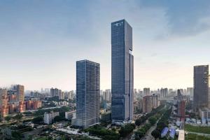 two tall skyscrapers in a large city at UrCove by Hyatt Guangzhou Tower Pazhou Exhibition Center in Guangzhou