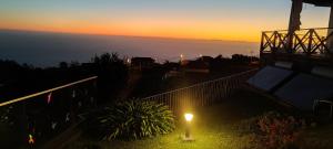 a view of the sunset from the balcony of a house at Horizon Retreat in Calheta