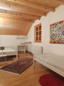 a room with two beds and a painting on the wall at Country Villa Velebit, Sveti Rok, Lika in Sveti Rok