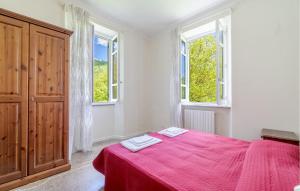 ein Schlafzimmer mit einem roten Bett mit zwei Handtüchern darauf in der Unterkunft 1 Bedroom Pet Friendly Apartment In Loco Di Rovegno in Torriglia