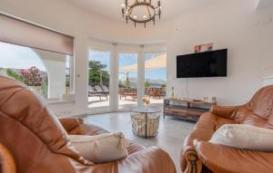 a living room with two leather chairs and a flat screen tv at Luxurious Home In Pag in Pag
