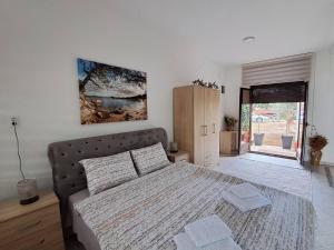 a bedroom with a bed with two pillows on it at Olive apartment in Podgorica