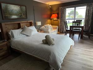 a bedroom with a large bed and a living room at Lakeview Holiday Hideaway in Taupo
