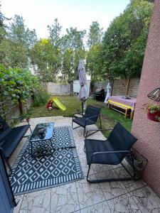 a patio with chairs and a table and an umbrella at Villa Mont D'Or in Manosque