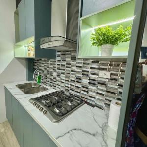 a kitchen counter with a stove and a sink at Suite para 3 in Crucita