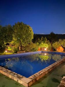 an image of a swimming pool at night at Blue Village Lux in Kolašin
