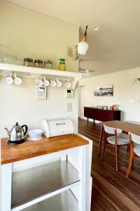 a kitchen with a table with a tea kettle on it at Surf Cottage KATAKAI-九十九里 片貝海岸- in Kujukuri