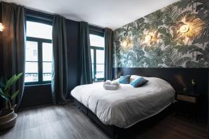- une chambre avec un lit et du papier peint tropical dans l'établissement Secret Walls, à Bruxelles