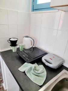 a kitchen counter with a toaster and a blender on it at Kalimera Studios and Apartments in Moraitika