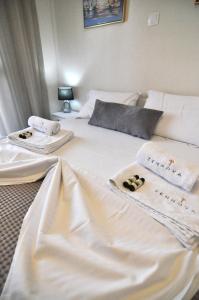 due letti in una stanza d'albergo con asciugamani sopra di Zennova #60, Nikiti Family Apt a Skála Nikíta