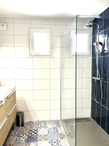ein Bad mit einer Dusche und einer Glastür in der Unterkunft M19*Marquer* T4 proche frontière in Annemasse