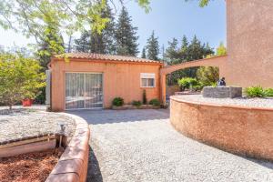 a house with a gate and a driveway at Logis Du Conflent in Rodès