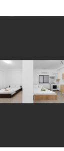 a white room with a bed and a table at Apartament Sunshine in Năvodari