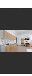 a kitchen with a sink and a table in a room at Apartament Sunshine in Năvodari
