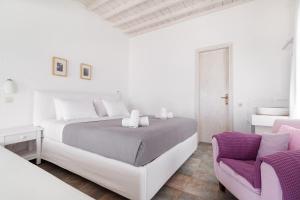 Rúm í herbergi á Fos Apartments Mykonos