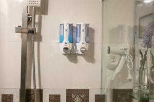 a bathroom with several electric toothbrushes on a wall at Hanoi Aria Central Hotel & Spa in Hanoi