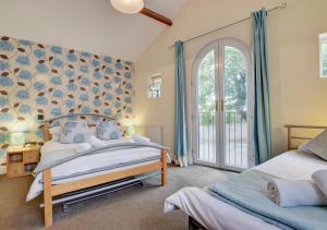 a bedroom with a bed and a glass door at Sunnyhill Mews in Torquay
