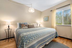 a bedroom with a bed with a blue comforter and a window at Sugarloaf Chalet 3BDR Garden View at Cedar 2510 in Cedar