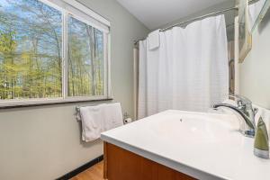 a bathroom with a sink and a window at Sugarloaf Chalet 3BDR Garden View at Cedar 2510 in Cedar