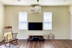 a living room with a flat screen tv and a chair at Surf Cottage KATAKAI-九十九里 片貝海岸- in Kujukuri +11 photos