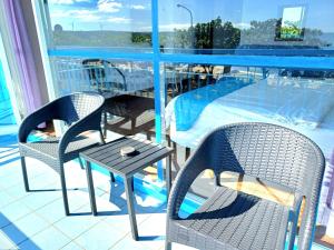 南灣的住宿－永旺旅店 Yong Wong Hostel，一个带桌椅的阳台和一个游泳池