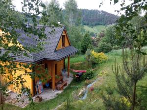 a tiny house in the middle of a field at Domek Stokrotka in Krynica Zdrój