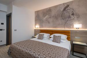 Ein Bett oder Betten in einem Zimmer der Unterkunft Hotel Ivka